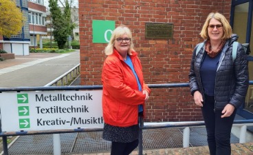 Frau Pfennig-Engel und Frau Unfried stehen am Eingang der Ausbildungswerkstätten