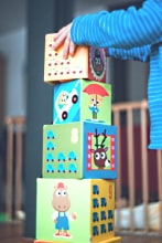 Inhaltsbild: Kinderhände bauen einen Turm aus Bauklötzen